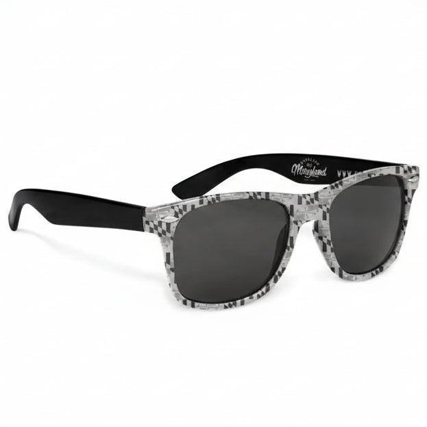 Sunglasses with black and white patterned frames on a white background